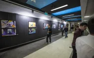 Galeria Pod Napięciem. Fotografie ptaków oprawione w czarne ramy wyeksponowane na ciemnym tle.