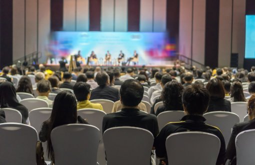 rear-view-of-audience-listening-speakers-on-the-stage-in-the-conference-hall-or-seminar-meeting.jpg	